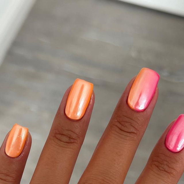 Playful Ombre Nail Design in Glossy Orange and Pink for Vibrant Summer Style.