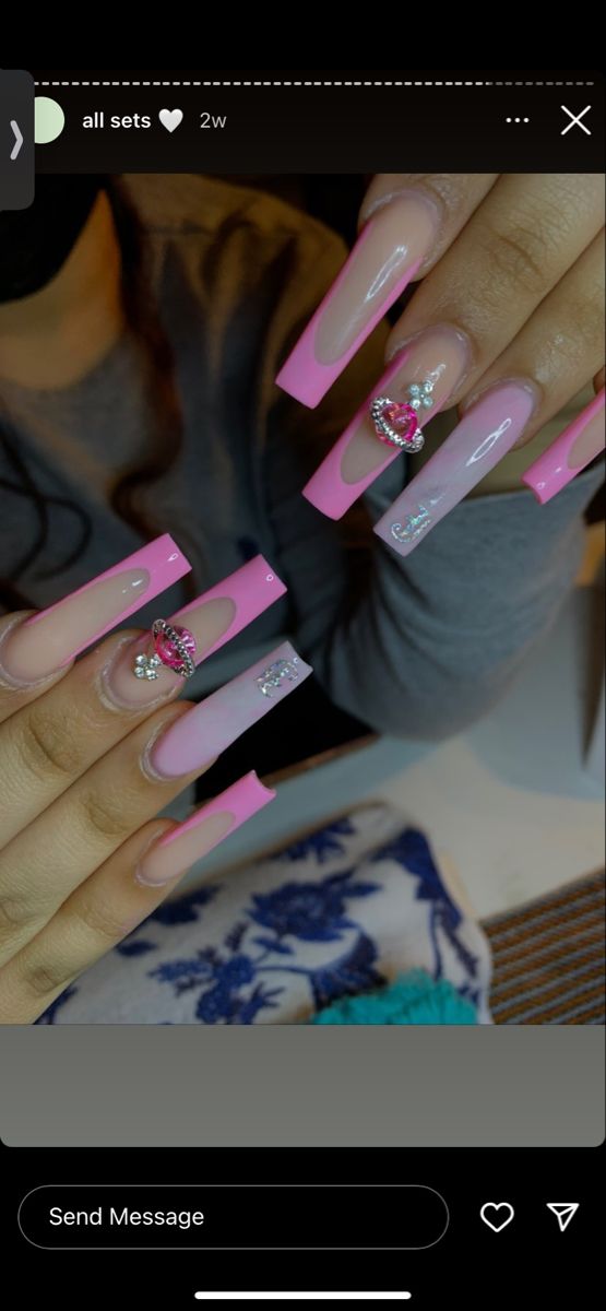 Chic Pink and Nude Nail Design with Sparkly Embellishments and Heart Charms