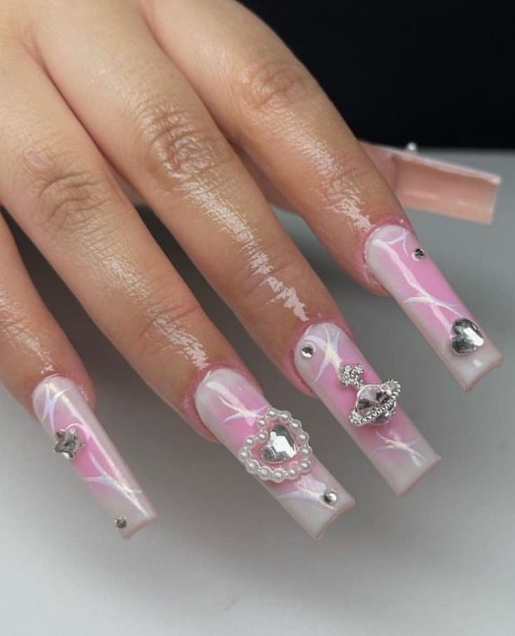 Whimsical Soft Pink Gradient Nail Design with Delicate Swirls and Charms.