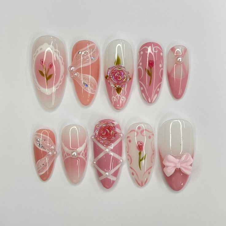 Elegant Soft Pink Nail Design with Floral Patterns and Glossy Finishes.