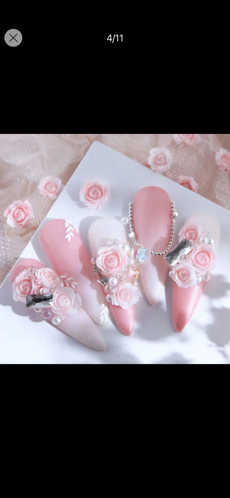 Romantic Soft Pink Nail Design with Floral Embellishments and Elegant Finishes.