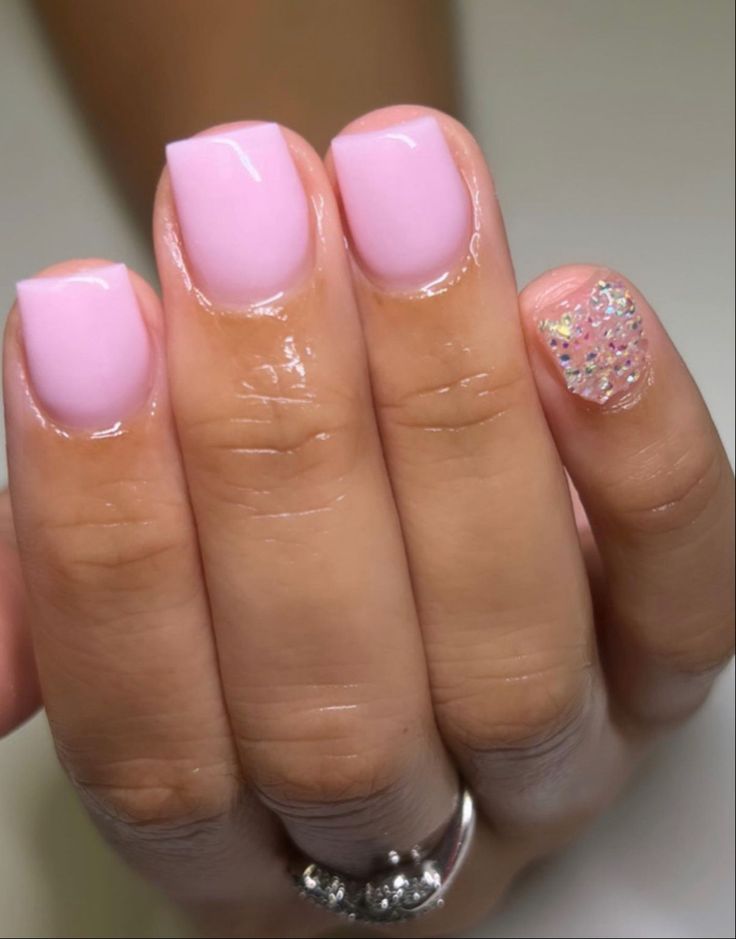 Sophisticated Soft Pink Nail Design with Glitter Accent for Glamorous Elegance.