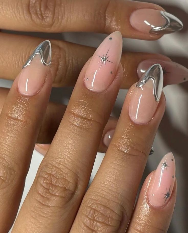 Chic Nail Design: Soft Pink Base with Metallic Silver Tips and Unique Starburst Patterns