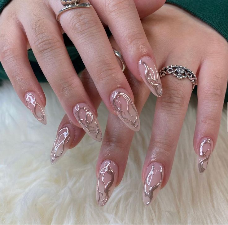 Sophisticated Almond-Shaped Nails with Nude Base and Artistic Abstract Designs.