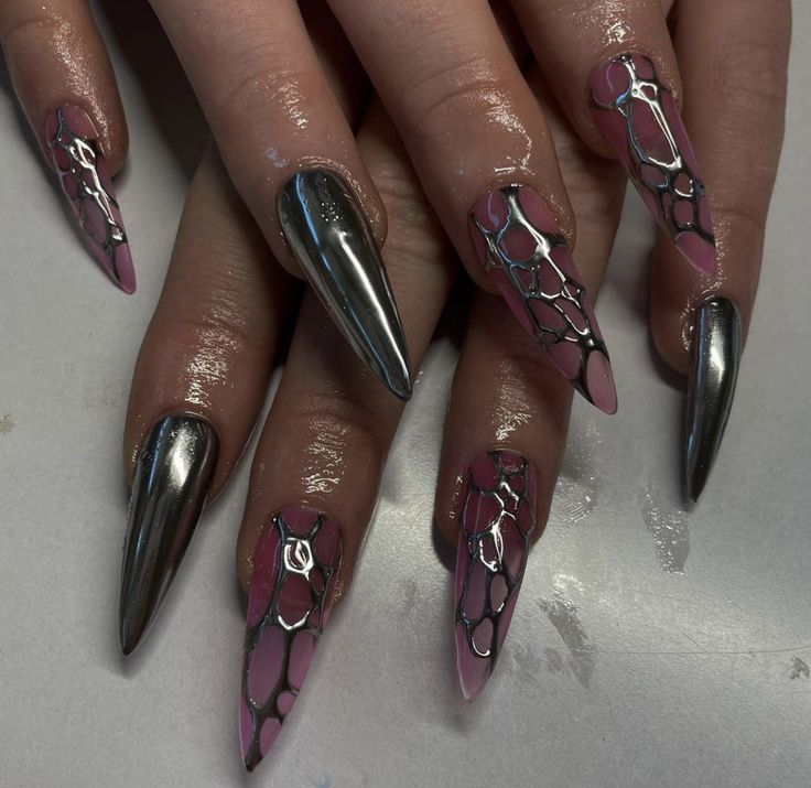 Dramatic Nail Design: Striking Metallic and Matte Finish with Intricate Silver Accents on Soft Pink.