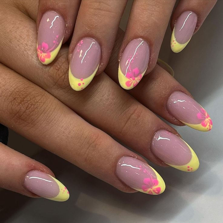 Playful Summer Nail Design: Pale Pink Base with Bold Yellow Tips and Charming Bright Pink Floral Accents