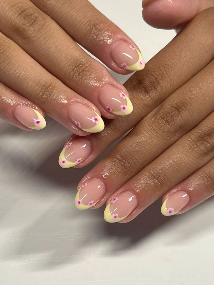 Whimsical Floral Nail Art with Nude Base and Yellow Tips for a Vibrant Spring Look.