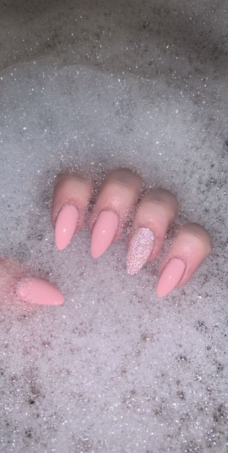 Chic Elegance: Textured Pink Nails with Sparkly Accent for Any Occasion.