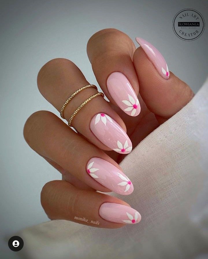 Elegant Spring Nail Design: Soft Pink Base with Floral Accents.