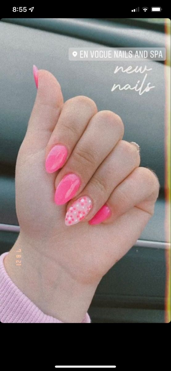 Playful Nail Design: Bright Pink Glossy Finish with Polka Dot Accent