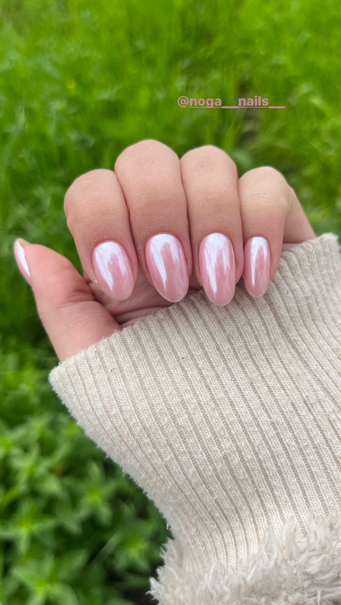 Sophisticated Almond-Shaped Nail Design in Soft Pink with Glossy Finish and Subtle Shimmer.