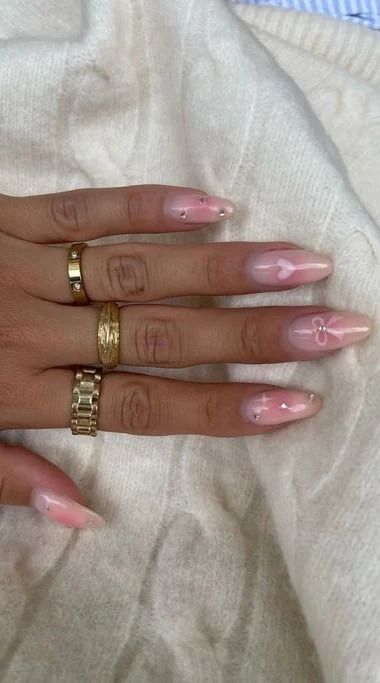 Sophisticated Soft Pink Nail Design with Delicate Details and Embellishments.