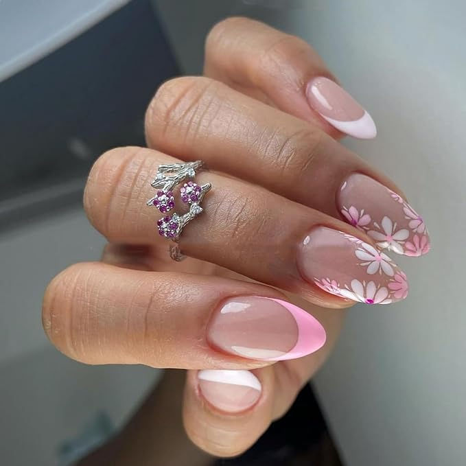 Elegant Nail Design: Soft Pink and Natural Tones with Whimsical Floral Patterns.