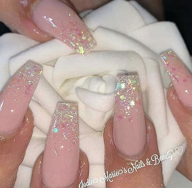 Sophisticated Long Pink Acrylic Nails with Glittery Accents and Iridescent Flakes.