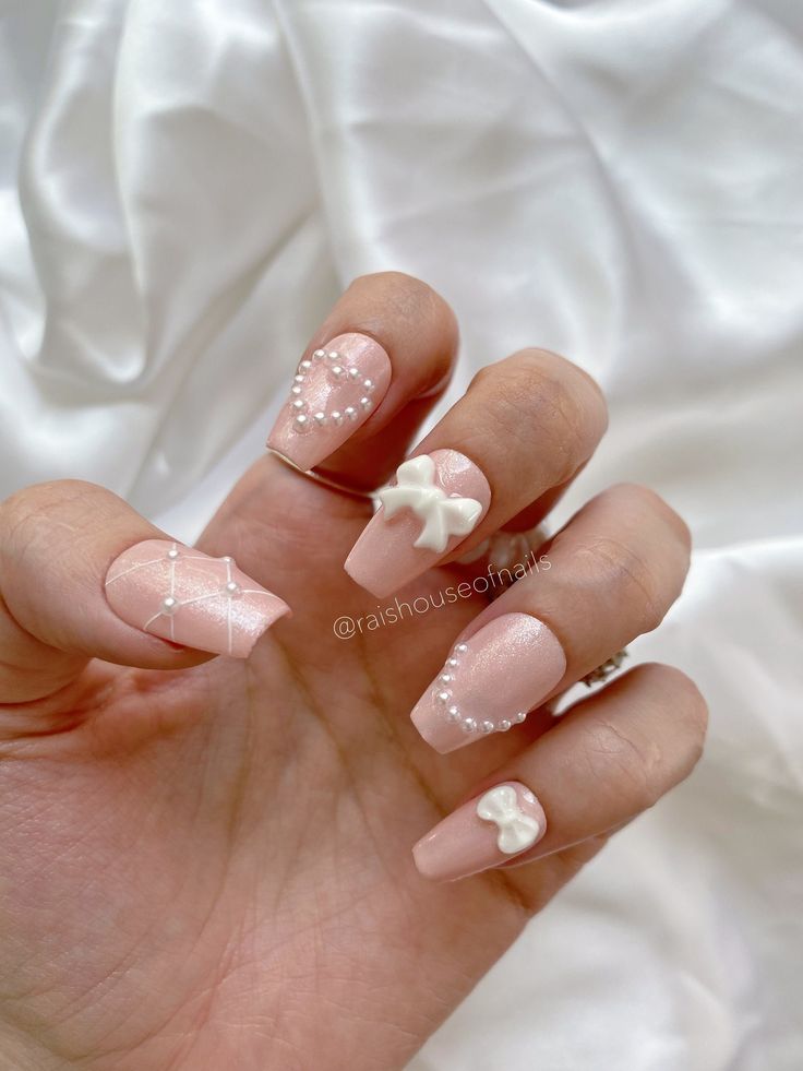 Elegant Soft Pink Nail Design with Whimsical Pearl Embellishments for Any Occasion