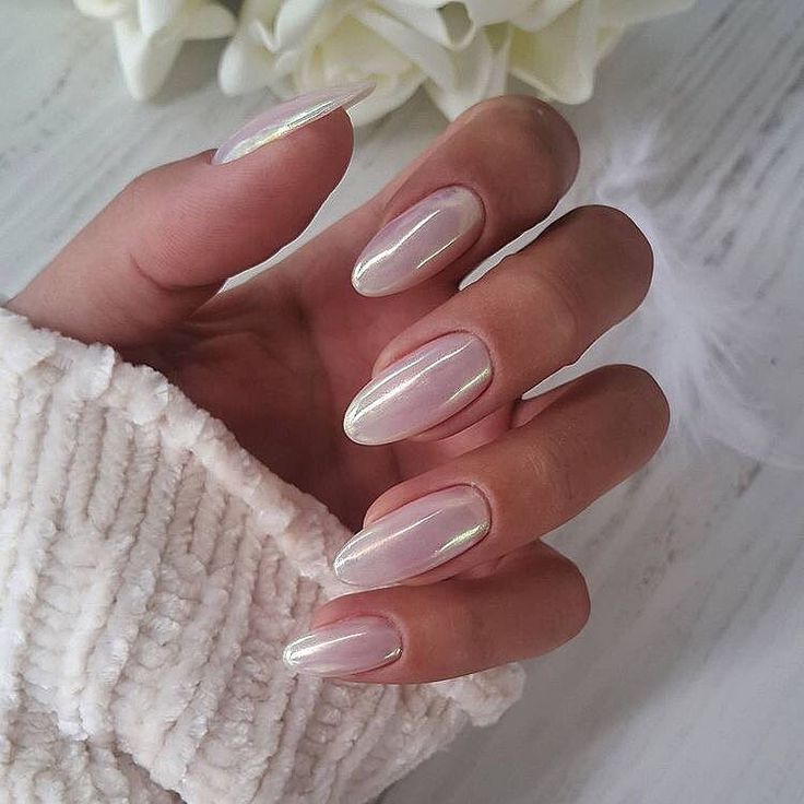 Elegant Almond-Shaped Nails with Iridescent Finish Complementing a Cozy Sweater.