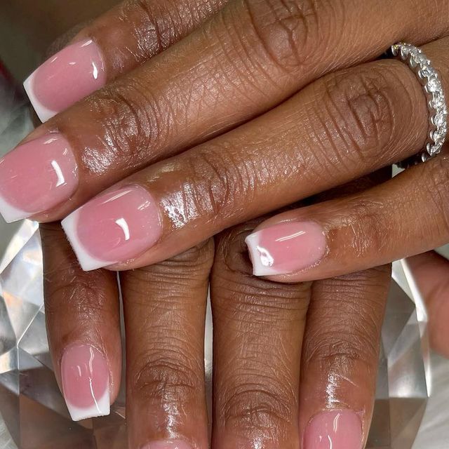 Timeless Chic: Elegant Soft Pink French Manicure with Glossy White Tips.