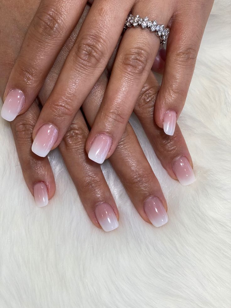 Sophisticated Ombre Nail Design: Delicate Pink to Translucent White for Understated Elegance.