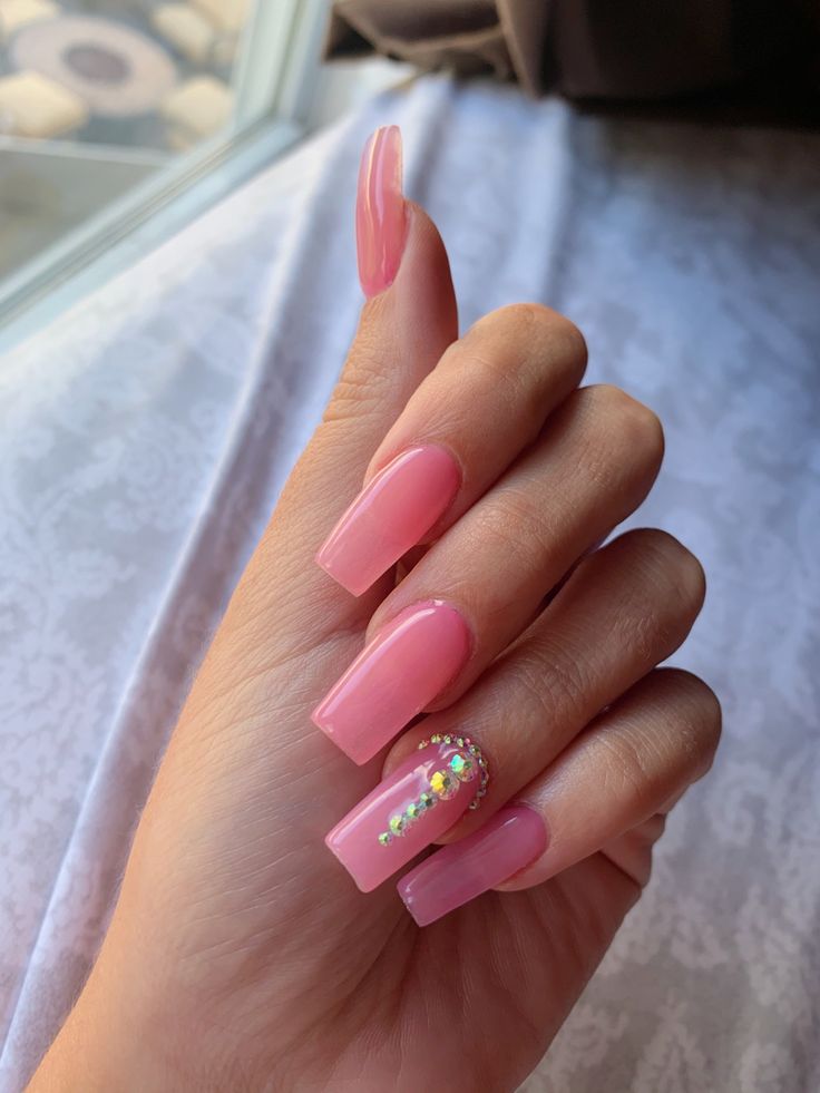 Chic Soft Pink Nail Design with Glossy Finish and Rhinestone Accent.