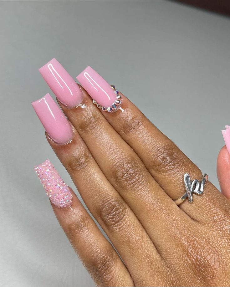 Chic Elegant Nail Design with Soft Pink Polish and Glamorous Accents