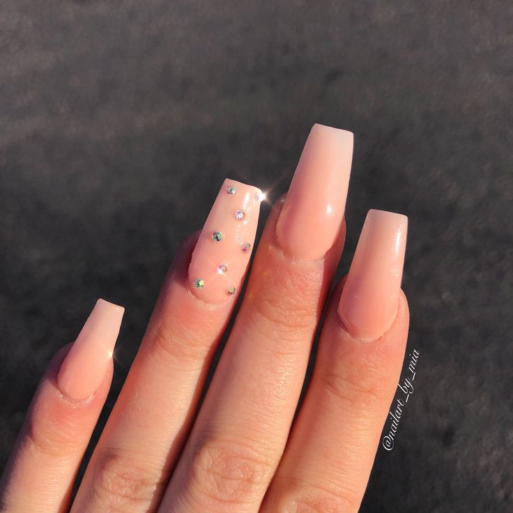 Chic Glossy Nude Nails with Rhinestone Accent for a Modern Elegance.