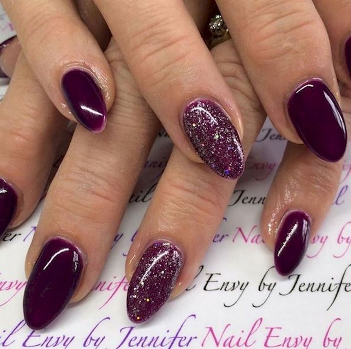 Sophisticated Almond-Shaped Purple Nail Design with Glossy and Glittery Accents.