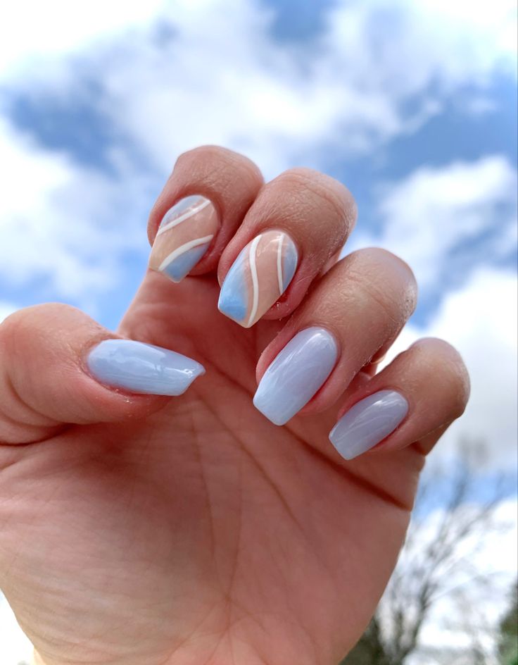 Elegantly Shaped Pastel Blue Nails with Geometric Patterns for a Serene Spring Aesthetic.