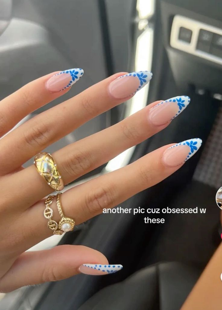 Charming French Tip Nail Art with Delicate Blue Floral Accents.