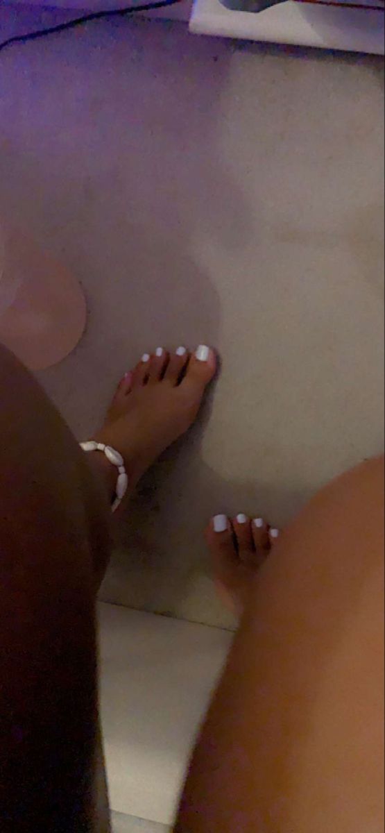 Stylish Pedicure: Pristine White Polish Accentuated by Ankle Bracelet