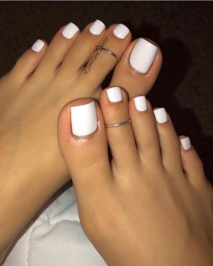 Elegant Fresh White Pedicure: Clean, Square Nails with Delicate Toe Rings for a Classic Summer Aesthetic.