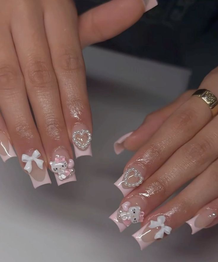 Playful Elegance: Soft Pink Nail Design with Intricate Embellishments and Sparkling Accents