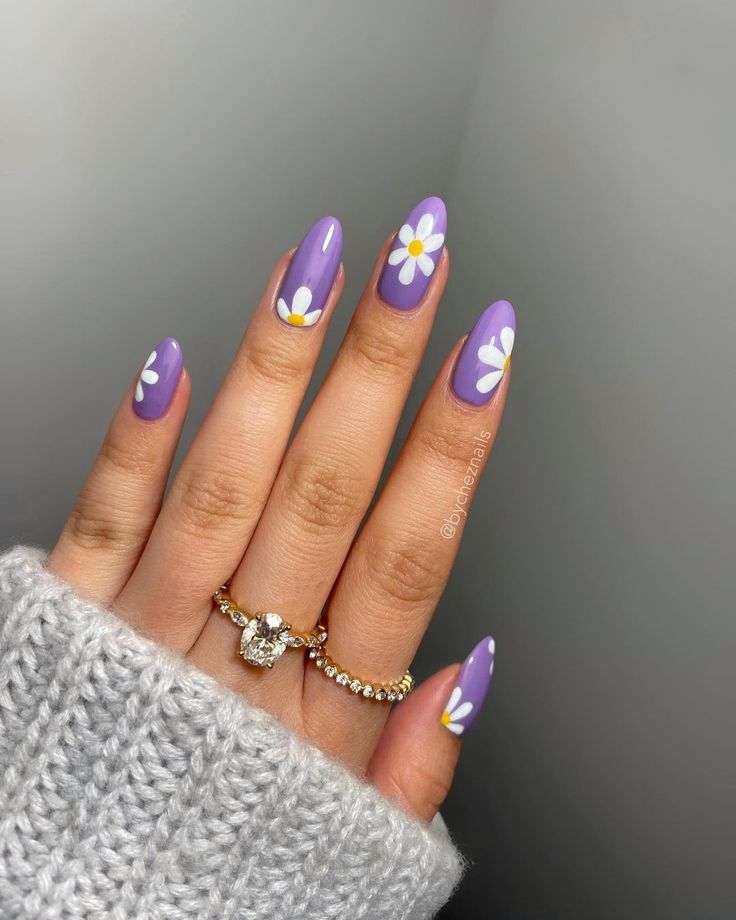 Cheerful Spring-Inspired Vibrant Purple Nails with Delicate Daisy Designs and Subtle Jewelry.