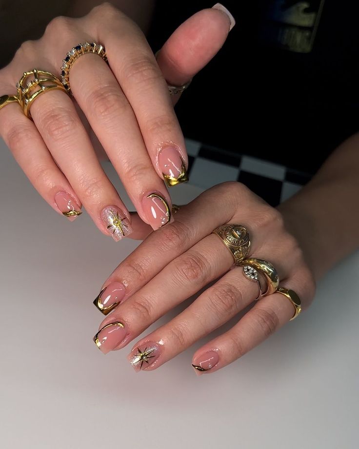 Chic Nail Design: Soft Nude Base with Intricate Gold Tips and Floral Accents