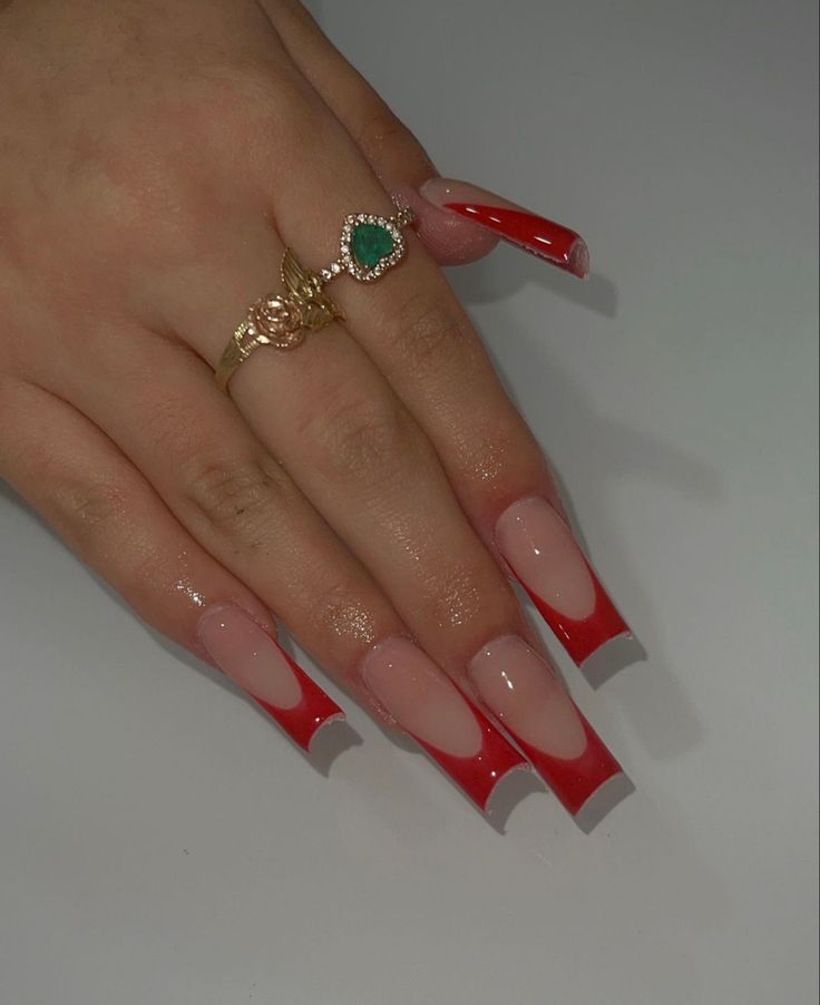 Bold Fashion Statement: Stunning Long Acrylic Nails with Vibrant Red French Tips and Elegant Jewelry.