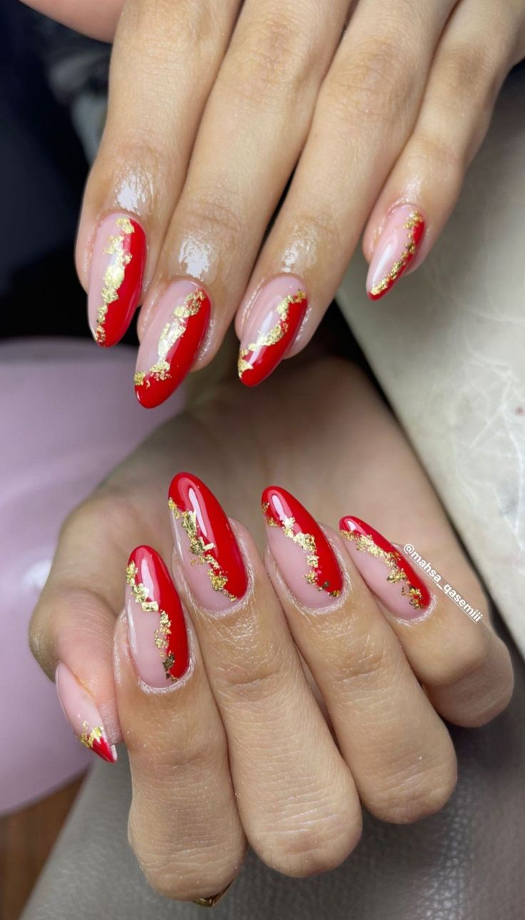 Glamorous Almond-Shaped Nails: Bold Red and Soft Nude with Gold Foil Accents.