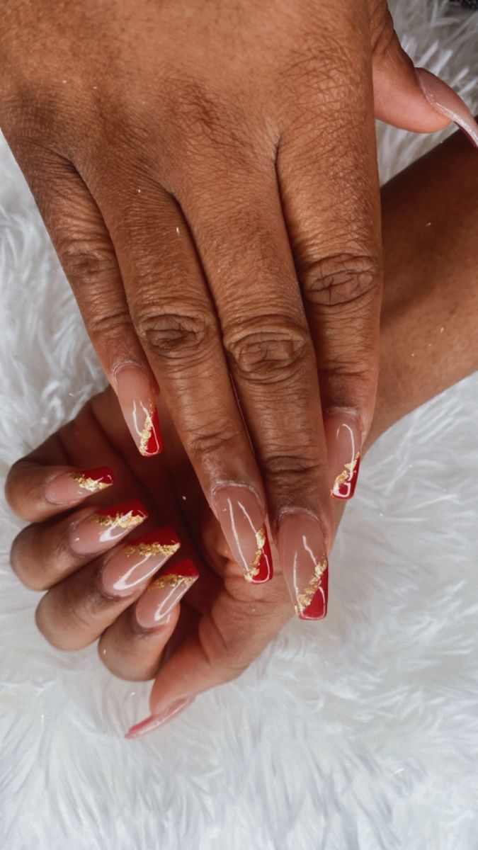 Chic Red-Tipped Nude Nails with Elegant Gold Accents