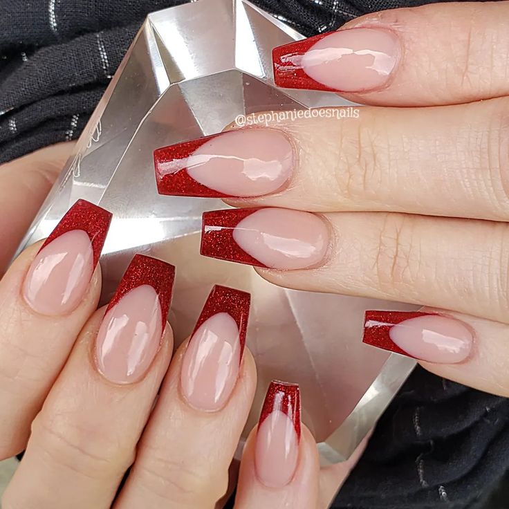 Chic Modern Twist on Classic French Manicure with Nude and Glossy Red Tips.