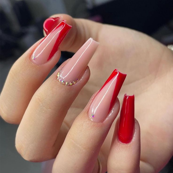 Chic Nail Design: Playful Blend of Nude and Bold Red with Sparkling Accents.