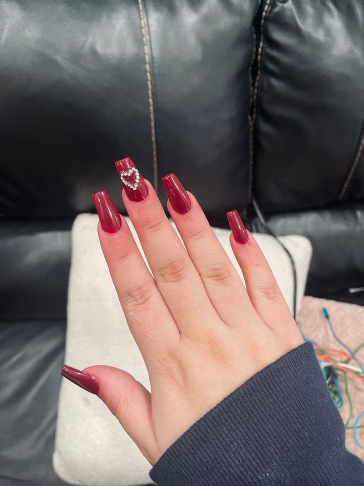 Sophisticated Glamour: Elegant Burgundy Nails with Center Gem Detail