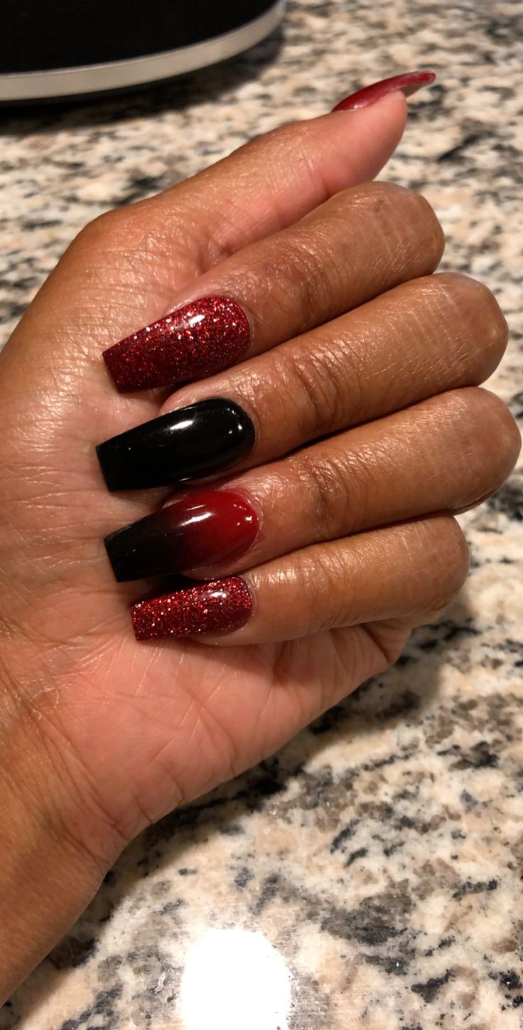 Glamorous Bold Nail Design with Gradient Red, Black, and Glitter Accents.