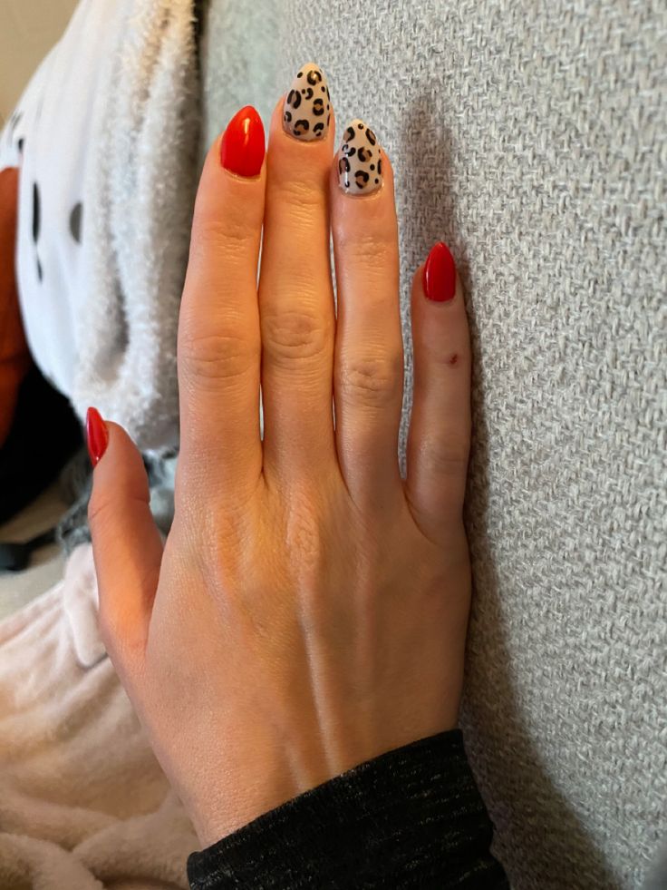 Bold Red Base with Stylish Leopard Print Accent Nails: A Chic and Trendy Nail Design.