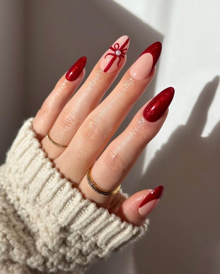 Festive Nail Design: Glossy Red Tips and Playful Gift Motif with Sparkly Finish