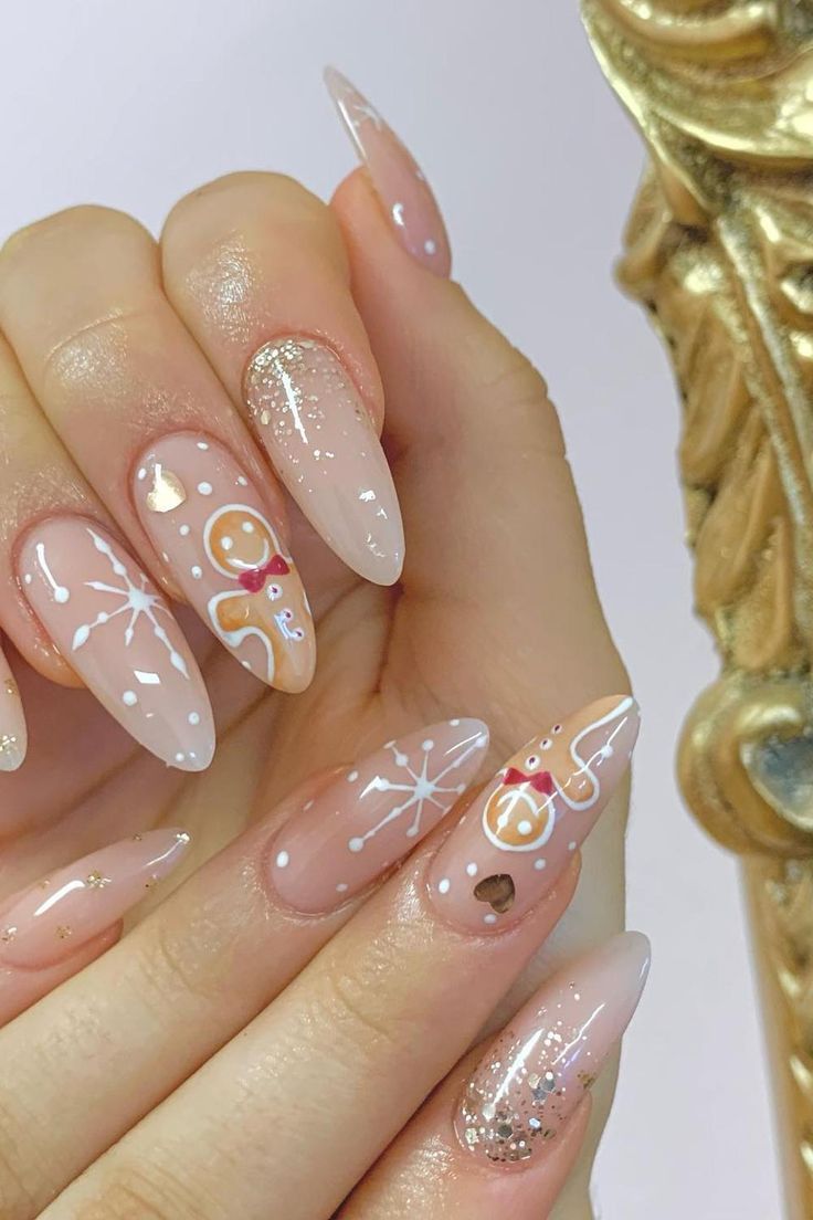 Whimsical Holiday Nails: Elegant Nude to Pink Gradient with Intricate White Patterns and Glitter Accents