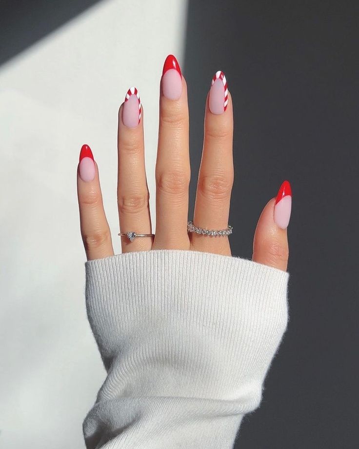 Chic Nail Design: Bold Red Tips with Playful Pink Patterns.