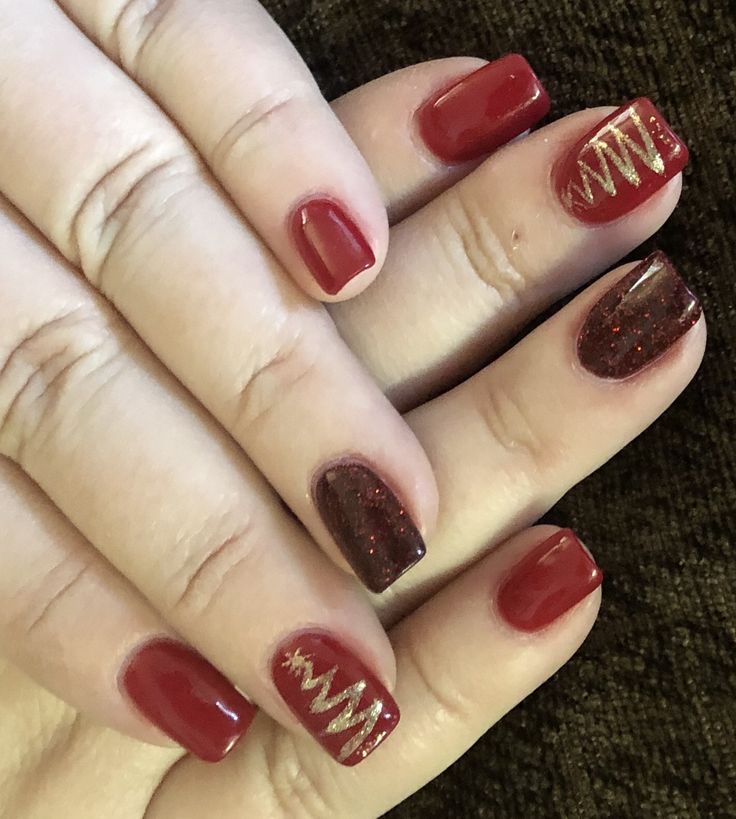 Vibrant Red and Deep Burgundy Nail Design with Glamorous Gold Accents