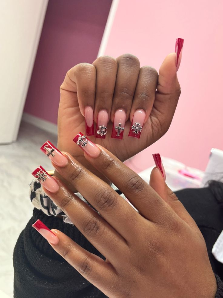 Sophisticated Elegant Nail Design: Soft Pink and Bold Red with Intricate Embellishments.