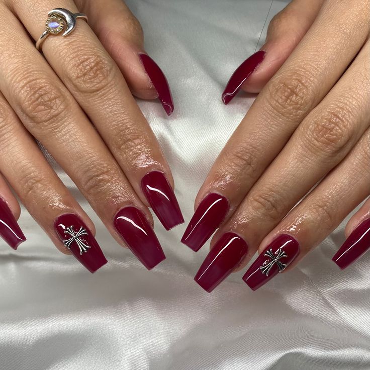 Elegant Glossy Burgundy Nails with Intricate Silver Accents for Any Occasion.