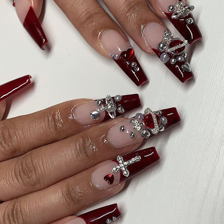 Chic Nail Design with Deep Red and Nude Tones, Embellished with Gems for Glamour.