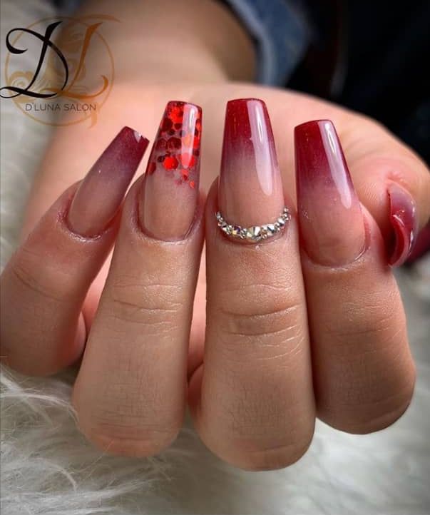 Elegant Ombre Nail Design with Deep Red Gradient and Glitter Accents