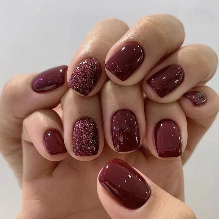 Sophisticated Elegant Burgundy Nails with Glossy Finish and Glamorous Accent.